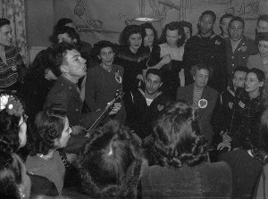 Pete Seeger, noted folk singer entertaining at the opening of the Washington labor canteen, with Eleanor Roosevelt